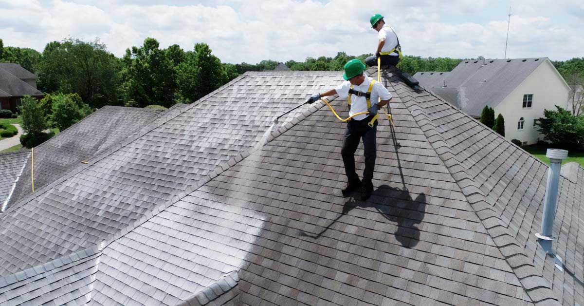 Workers applying Roof Maxx to a roof