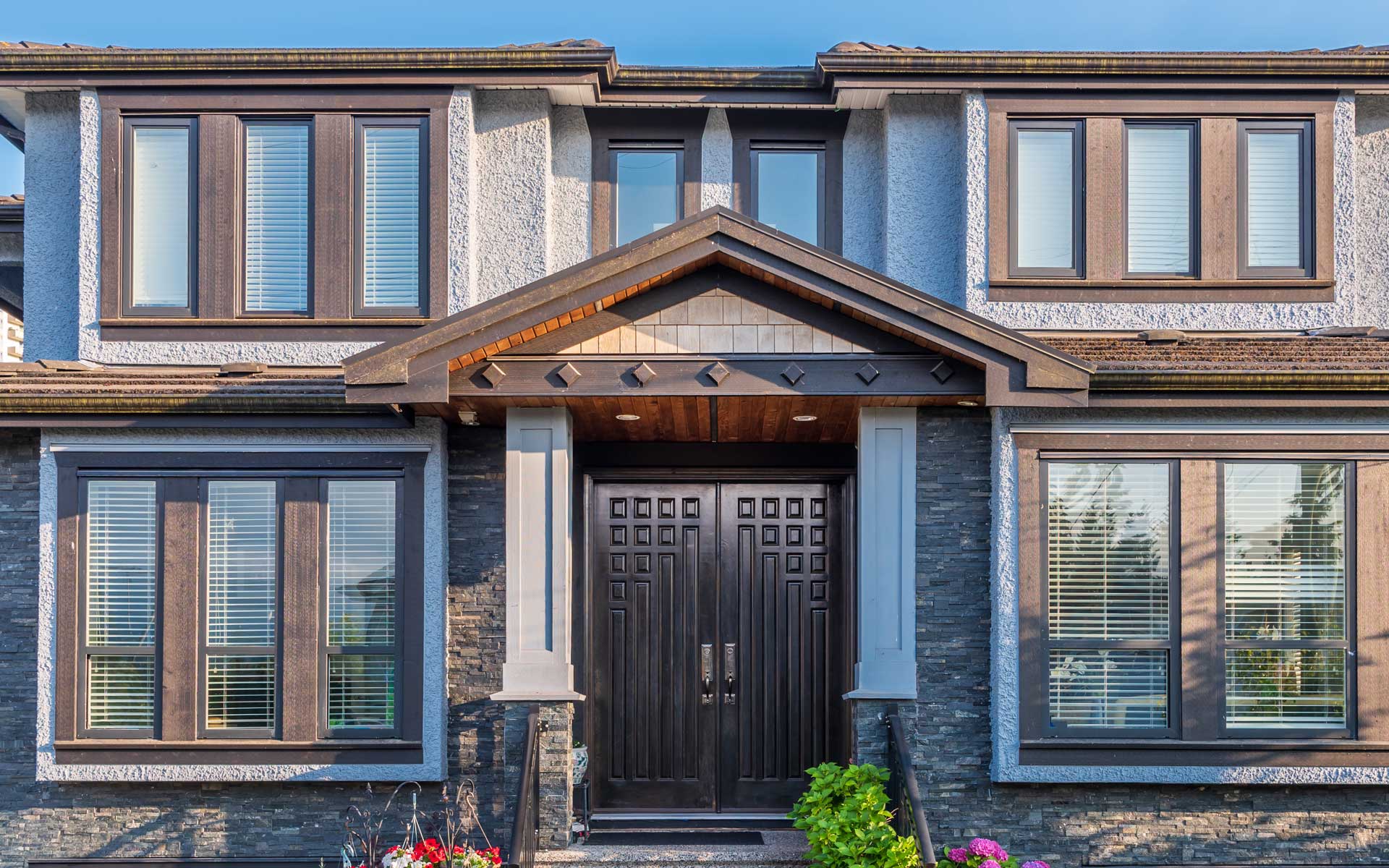 house-stone-stucco-black-windows-double-door-entry